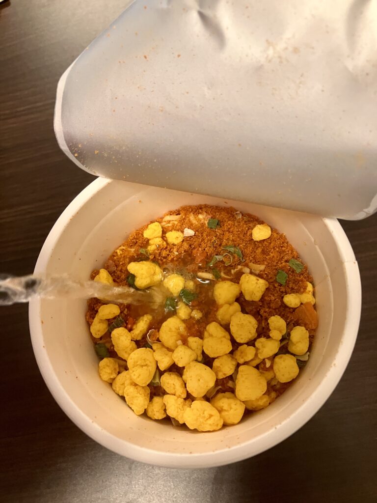 Pouring hot water into cup ramen