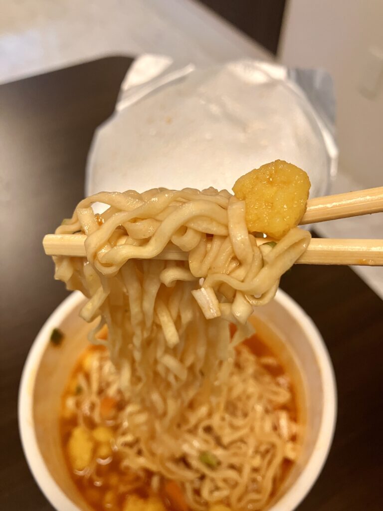 Picking up instant ramen with chopsticks