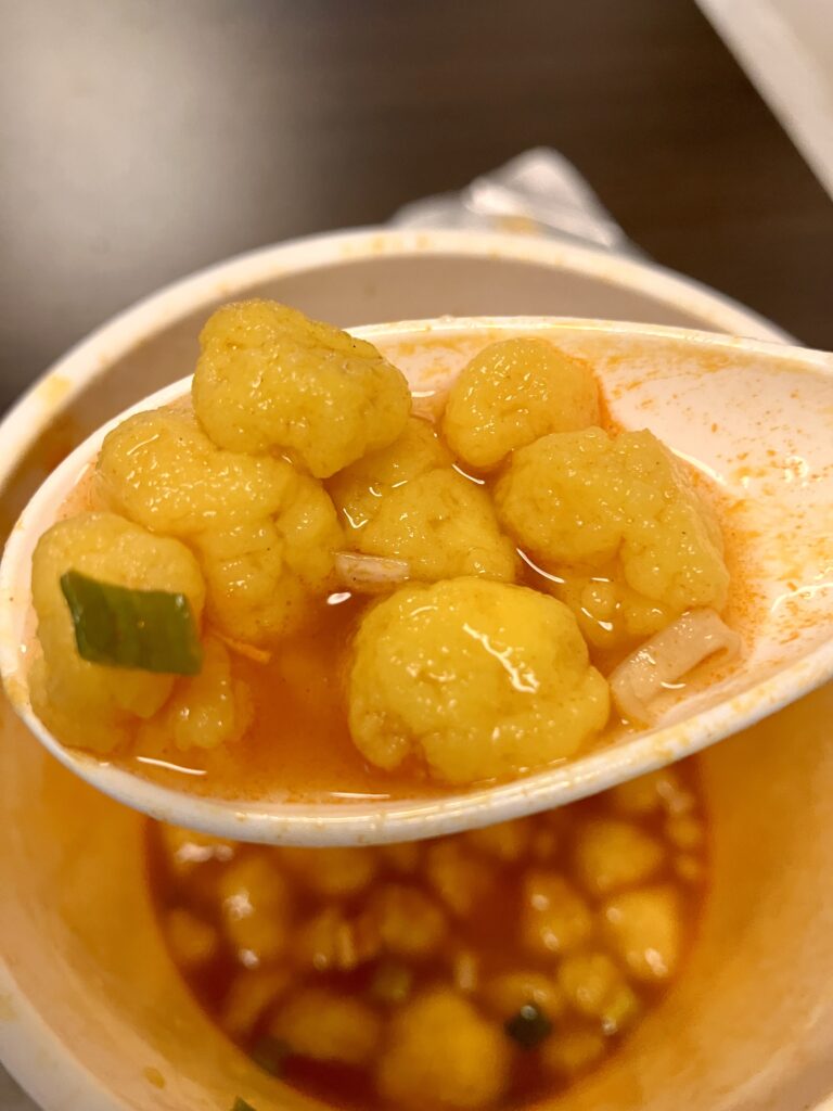 Photo of an egg being lifted with a spoon