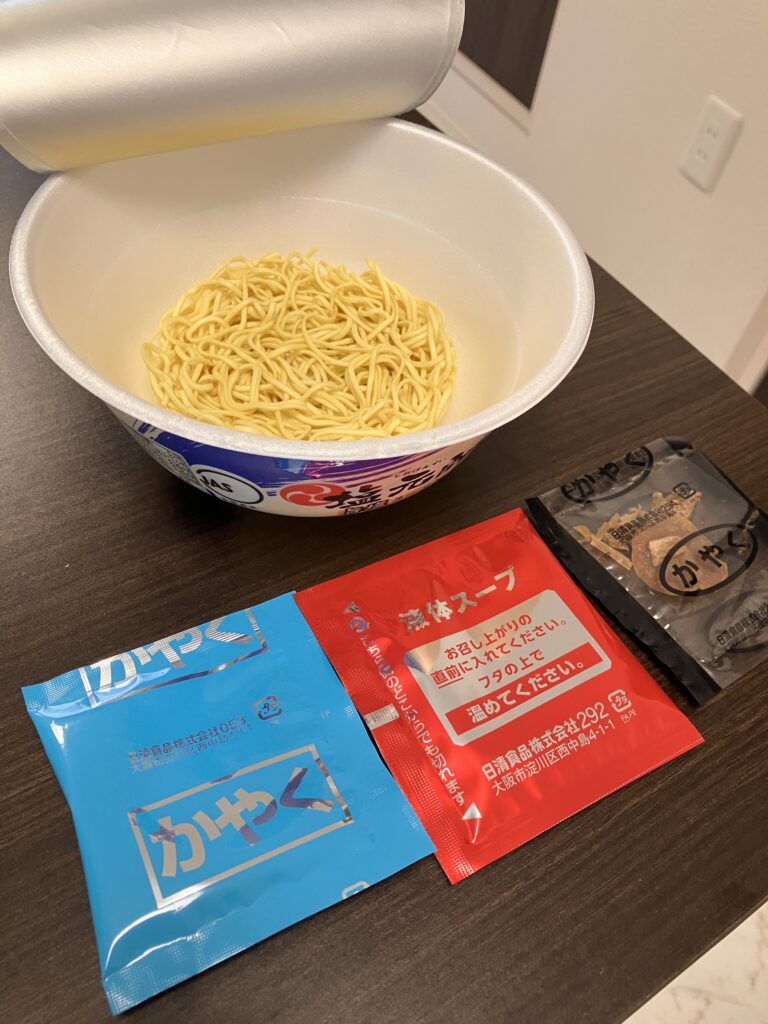 A photo of an opened cup noodle showing the ingredients inside