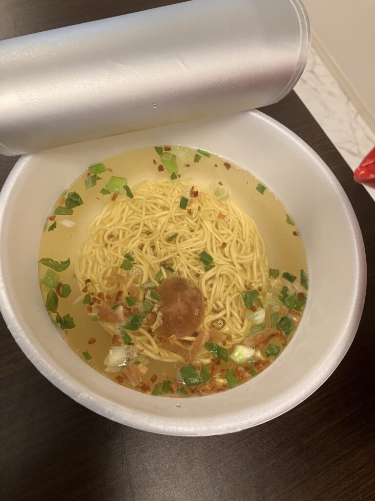 A photo of pouring hot water into a cup noodle