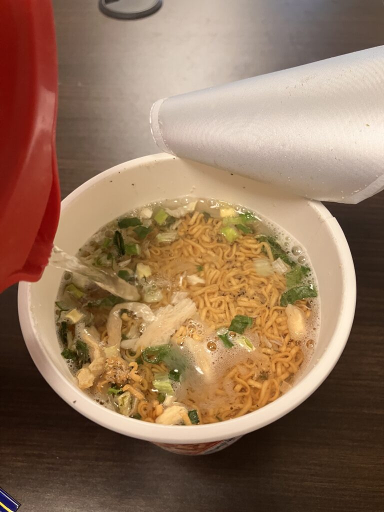 Photo of pouring hot water into cup ramen