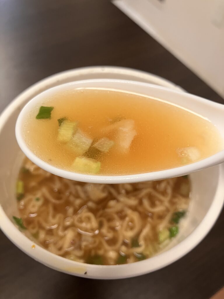 Photo of lifting cup ramen soup with a spoon