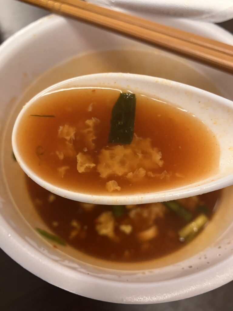 Photo of lifting cup ramen soup with a spoon