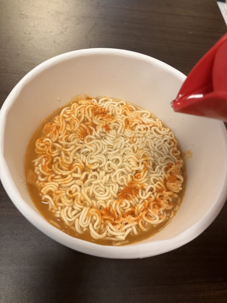 Pouring hot water into cup ramen